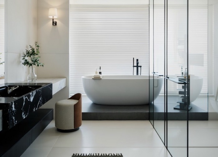 Freestanding bath and concealed fittings in a hotel bathroom