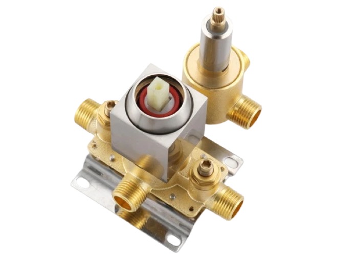 Ceramic cartridges beside a brass valve body