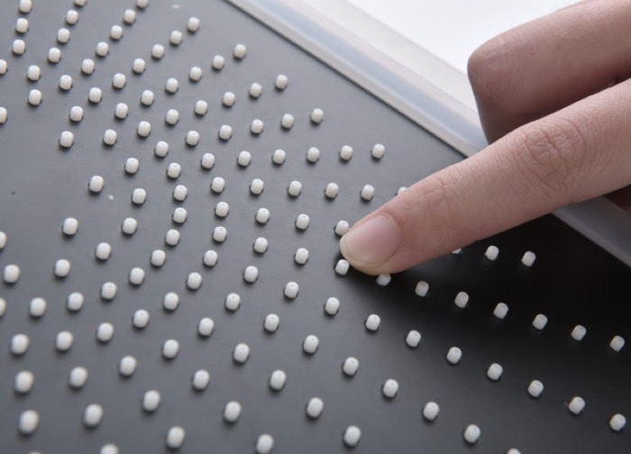 Silicone nozzle plate on a shower head being checked