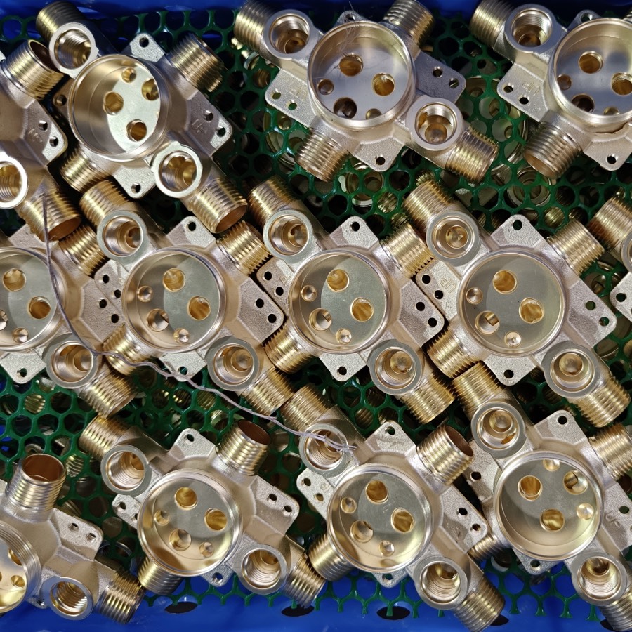 Batch of machined brass valve bodies prepared for regional thread standards